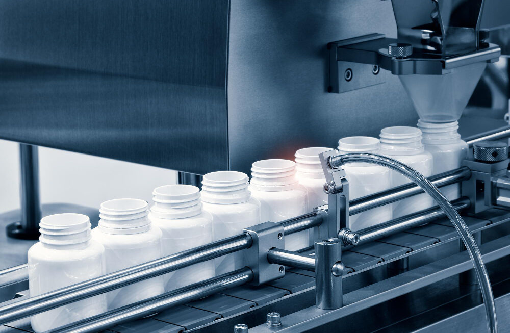 Vision inspection system examining plastic bottles on a conveyor line for automated quality control and defect detection.