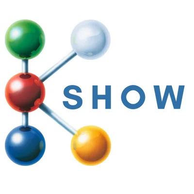 K Show logo featuring a molecular-inspired graphic with colorful connected spheres and the text "SHOW."